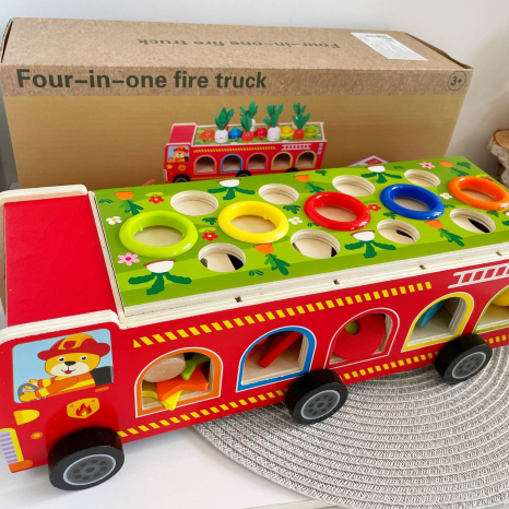 Дерев'яна багатофункціональна іграшка Пожежна машина (геометричний сортер, стукатка, грядка з морквинами), C 68271