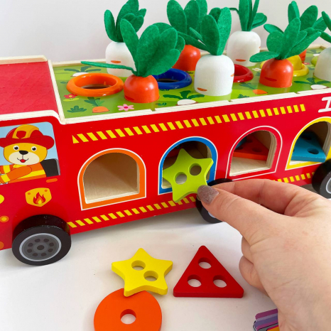 Дерев'яна багатофункціональна іграшка Пожежна машина (геометричний сортер, стукатка, грядка з морквинами), C 68271