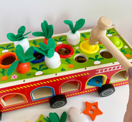 Дерев'яна багатофункціональна іграшка Пожежна машина (геометричний сортер, стукатка, грядка з морквинами), C 68271
